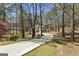 Long driveway leads to a beautiful house on a lot surrounded by tall trees at 5163 Holly Springs Dr, Douglasville, GA 30135