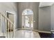 Welcoming foyer with beautiful arch top door, tile floor, and neutral paint at 5163 Holly Springs Dr, Douglasville, GA 30135