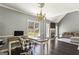 Spacious home office with a comfortable chair and views into the living area at 5163 Holly Springs Dr, Douglasville, GA 30135