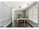 Bright home office featuring a stylish desk, chandelier, and ample natural light at 5163 Holly Springs Dr, Douglasville, GA 30135