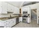 Well-equipped kitchen featuring stainless steel appliances and white cabinetry at 5163 Holly Springs Dr, Douglasville, GA 30135
