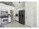 Bright kitchen with white cabinets, stainless steel appliances and tile flooring at 5163 Holly Springs Dr, Douglasville, GA 30135