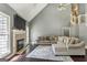 Inviting living area with a fireplace, large windows, and a comfortable sectional sofa at 5163 Holly Springs Dr, Douglasville, GA 30135