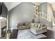 Cozy living room with a fireplace, sectional couch, and view of the staircase at 5163 Holly Springs Dr, Douglasville, GA 30135