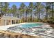 Community pool surrounded by a deck with chairs, perfect for relaxing and enjoying the summer at 5163 Holly Springs Dr, Douglasville, GA 30135