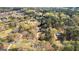 Expansive aerial view of a home nestled among lush trees in a peaceful neighborhood, near a small lake at 135 Horseshoe Cir, Fayetteville, GA 30215