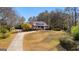 Stunning aerial view of a home with a large yard, mature trees, and a charming front porch at 135 Horseshoe Cir, Fayetteville, GA 30215