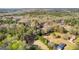 Expansive aerial view showcases the home nestled among a beautiful, lush green forest and sprawling lawn at 135 Horseshoe Cir, Fayetteville, GA 30215