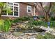 Serene backyard with decorative waterfall, rock features and mature landscaping at 135 Horseshoe Cir, Fayetteville, GA 30215
