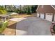 Spacious backyard featuring a large paved area, shed, and carport perfect for outdoor activities at 135 Horseshoe Cir, Fayetteville, GA 30215
