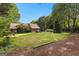 Spacious backyard featuring a lush lawn, mature trees, and a tranquil setting, ideal for outdoor enjoyment at 135 Horseshoe Cir, Fayetteville, GA 30215