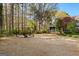 Expansive backyard featuring a classic gazebo surrounded by mature trees and lush foliage at 135 Horseshoe Cir, Fayetteville, GA 30215