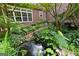 View of backyard showing water feature with waterfall and lush foliage at 135 Horseshoe Cir, Fayetteville, GA 30215