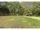 Expansive backyard featuring mature trees, lush greenery, a shed, and a relaxing outdoor environment at 135 Horseshoe Cir, Fayetteville, GA 30215