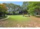 Expansive backyard with a pergola, lush lawn, surrounded by mature trees, offering a serene outdoor space at 135 Horseshoe Cir, Fayetteville, GA 30215