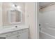 Bathroom featuring a vanity with an ornate mirror, and a shower-tub combo at 135 Horseshoe Cir, Fayetteville, GA 30215