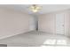 Bedroom with neutral walls, carpet, ceiling fan, and closet doors at 135 Horseshoe Cir, Fayetteville, GA 30215