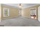 Light-filled bedroom featuring neutral carpet and windows with outdoor views at 135 Horseshoe Cir, Fayetteville, GA 30215