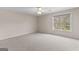Bright bedroom with carpet, a ceiling fan, and scenic outside views at 135 Horseshoe Cir, Fayetteville, GA 30215