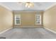 Bright bedroom features neutral walls, soft carpet and a ceiling fan with lights at 135 Horseshoe Cir, Fayetteville, GA 30215