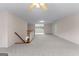 Open bonus room with carpet, a staircase, and a view into another room at 135 Horseshoe Cir, Fayetteville, GA 30215