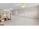Spacious bonus room features neutral carpet, a ceiling fan, and staircase access at 135 Horseshoe Cir, Fayetteville, GA 30215