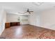 Bright bonus room with brick floors, built in shelves and desk, and a ceiling fan at 135 Horseshoe Cir, Fayetteville, GA 30215