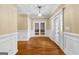 Grand entryway with hardwood floors, elegant lighting, and glass-paneled doors at 135 Horseshoe Cir, Fayetteville, GA 30215