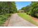 Scenic view of a home from a long driveway showcasing a beautiful lawn at 135 Horseshoe Cir, Fayetteville, GA 30215