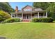 Charming two-story home with a welcoming front porch and manicured lawn at 135 Horseshoe Cir, Fayetteville, GA 30215