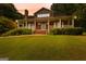 Charming two-story home with a welcoming front porch and manicured lawn at 135 Horseshoe Cir, Fayetteville, GA 30215