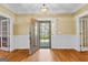 Elegant foyer with hardwood floors, white trim, and an ornate front door, creating a grand entrance to the home at 135 Horseshoe Cir, Fayetteville, GA 30215