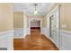 Inviting foyer showcasing hardwood floors, white trim, and a view into a room with unique striped wallpaper at 135 Horseshoe Cir, Fayetteville, GA 30215