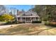 Beautiful front exterior with a welcoming porch and well-manicured lawn at 135 Horseshoe Cir, Fayetteville, GA 30215