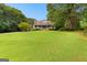 Expansive front lawn leading to a home with a welcoming front porch at 135 Horseshoe Cir, Fayetteville, GA 30215