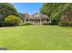 Spacious front yard with lush green lawn leading to a home with a covered porch at 135 Horseshoe Cir, Fayetteville, GA 30215