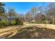 Lawn view of a picturesque front yard featuring lush greenery and a well-maintained landscape, showcasing natural beauty at 135 Horseshoe Cir, Fayetteville, GA 30215