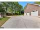 Spacious driveway leading to a three-car garage and covered parking area at 135 Horseshoe Cir, Fayetteville, GA 30215