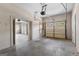 Open two car garage with two overhead doors with view through open doorway to another garage at 135 Horseshoe Cir, Fayetteville, GA 30215