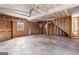 Large unfinished garage with overhead door, exposed beams, and plywood walls at 135 Horseshoe Cir, Fayetteville, GA 30215