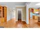 Hallway with hardwood floors leads to kitchen and staircase at 135 Horseshoe Cir, Fayetteville, GA 30215