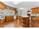 Traditional kitchen features oak cabinets, an island with seating, and an eat-in nook area at 135 Horseshoe Cir, Fayetteville, GA 30215