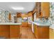 Spacious kitchen boasts oak cabinets, an island with bar seating, and hardwood floors at 135 Horseshoe Cir, Fayetteville, GA 30215