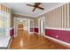Inviting living room boasting gleaming hardwood floors, ceiling fan, and french doors at 135 Horseshoe Cir, Fayetteville, GA 30215