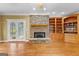 Living room showcasing hardwood floors, a stone fireplace, and natural light at 135 Horseshoe Cir, Fayetteville, GA 30215