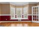 Charming living room with hardwood floors, decorative wall trim, and bright bay windows at 135 Horseshoe Cir, Fayetteville, GA 30215