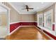 Charming living room with a hardwood floor, ceiling fan, and bright windows at 135 Horseshoe Cir, Fayetteville, GA 30215