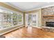 Living room with hardwood flooring, fireplace, windows, and french doors to outdoor at 135 Horseshoe Cir, Fayetteville, GA 30215