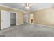 Spacious main bedroom features neutral carpeting, ceiling fan, closet and ensuite access at 135 Horseshoe Cir, Fayetteville, GA 30215