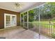 A screened-in porch featuring tile flooring and a view of the private backyard at 135 Horseshoe Cir, Fayetteville, GA 30215